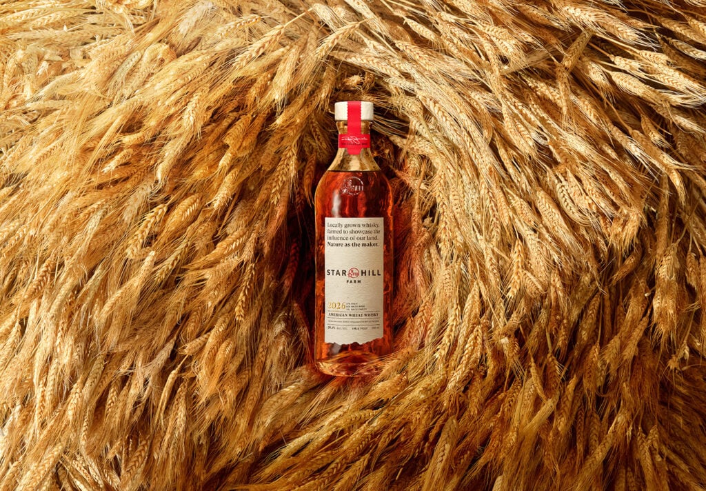 A bottle of Star Hill Farm Whisky 2026 in pile of wheat