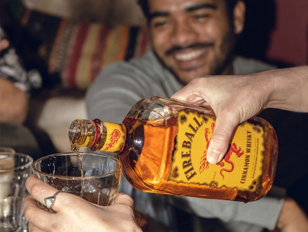 Pouring a drink of Fireball Cinnamon Whisky Liqueur