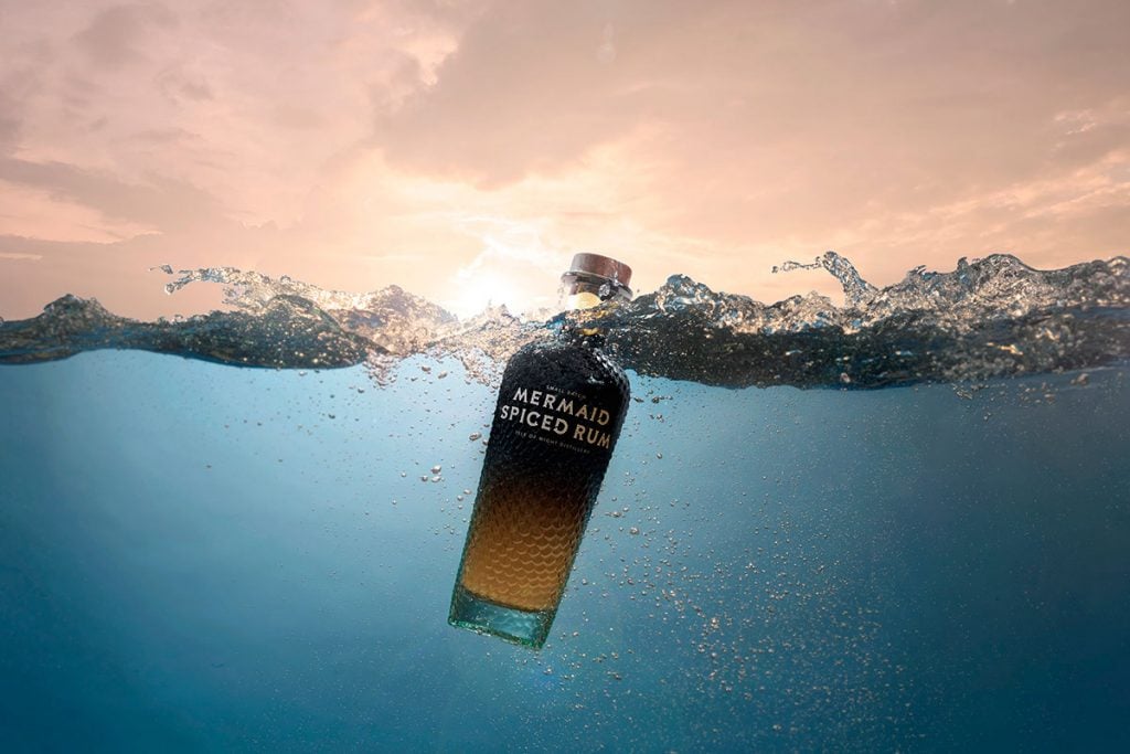 A bottle of Mermaid Spiced Rum in the sea